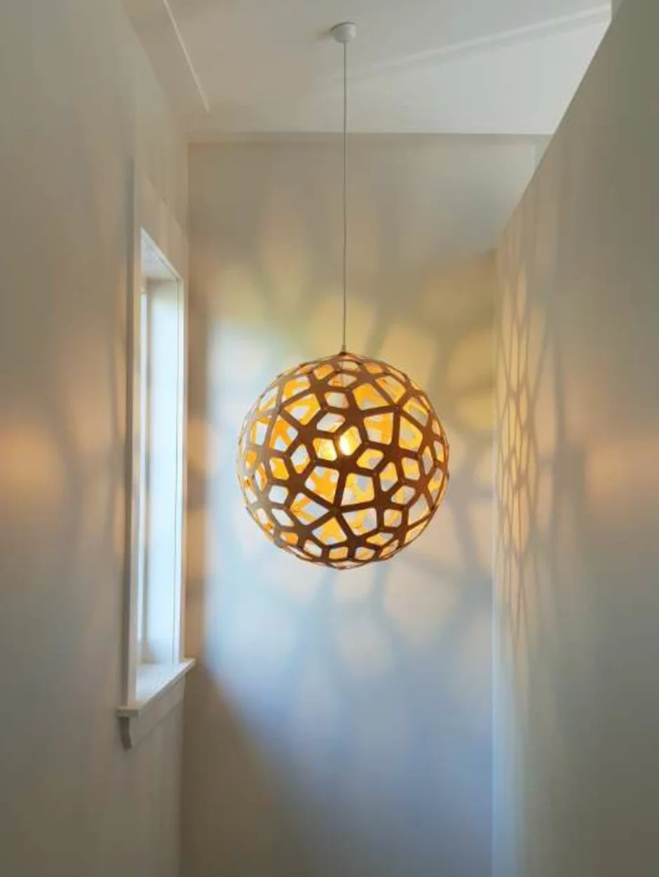 Designer pendant light installation in residential hallway